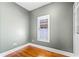 Cozy bedroom with hardwood floors, a window for natural light, and a closet for storage at 1900 Garvin St, Orlando, FL 32803