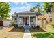 Charming home with inviting front porch, manicured lawn, and walkway leading to the entrance at 1900 Garvin St, Orlando, FL 32803