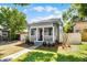 Charming home with inviting front porch, manicured lawn, and walkway leading to the entrance at 1900 Garvin St, Orlando, FL 32803