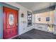 Close up of a front porch with a red door, hanging lantern, and swing at 1900 Garvin St, Orlando, FL 32803
