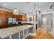 Modern kitchen boasts stainless steel appliances, wooden cabinets, granite countertops, and pendant lighting at 1900 Garvin St, Orlando, FL 32803