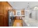 Spacious kitchen features stainless steel appliances, wooden cabinets, granite countertops, and a large island at 1900 Garvin St, Orlando, FL 32803
