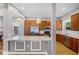 Bright kitchen with stainless steel appliances, wooden cabinets, a granite island, and modern pendant lights at 1900 Garvin St, Orlando, FL 32803