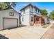 Two-story home featuring a detached garage, paved backyard, and a cozy wooden pergola at 1900 Garvin St, Orlando, FL 32803