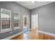 Bright room with natural light, hardwood floors, three windows, and a door leading to an outdoor area at 1900 Garvin St, Orlando, FL 32803