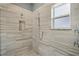 Elegant shower area featuring marble-style tiling, a rainfall showerhead, and modern fixtures, creating a spa-like retreat at 1900 Garvin St, Orlando, FL 32803