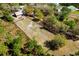 Aerial view of a property with paddocks, and outbuildings surrounded by trees at 20773 Starry St, Orlando, FL 32833