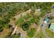 Expansive aerial view of the property showcasing lush greenery, pond, various structures, and serene surroundings at 20773 Starry St, Orlando, FL 32833