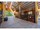 Interior view of barn showing metal roof, wood framing, and horse stalls creating a functional space for animals and equipment at 20773 Starry St, Orlando, FL 32833