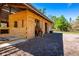 Barn exterior featuring a horse eating hay with views of a wooden fence and mature trees at 20773 Starry St, Orlando, FL 32833