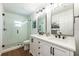Modern bathroom with a double vanity, sleek fixtures, and a glass-enclosed shower at 20773 Starry St, Orlando, FL 32833