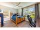 Bright bedroom with hardwood floors, a cozy bed, and a view of the outside greenery at 20773 Starry St, Orlando, FL 32833