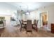 Inviting dining room with wood floors, stylish chandelier, and kitchen access at 20773 Starry St, Orlando, FL 32833
