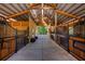 Spacious horse barn with wooden stalls and a well-maintained concrete floor at 20773 Starry St, Orlando, FL 32833
