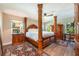 Elegantly appointed main bedroom featuring a four-poster bed and wood flooring at 20773 Starry St, Orlando, FL 32833