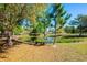 Scenic view of a pond with lily pads surrounded by lush greenery and autumn leaves at 20773 Starry St, Orlando, FL 32833