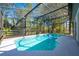 Beautiful in-ground pool in screened enclosure with fence and lush surrounding at 20773 Starry St, Orlando, FL 32833