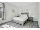 This bedroom has luxury vinyl plank flooring, a gray wood bed frame, two night stands, and decorative wall art at 2348 Victoria Dr, Davenport, FL 33837