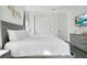 This bedroom has luxury vinyl plank flooring, a gray wood bed frame, and a gray dresser with a TV on top at 2348 Victoria Dr, Davenport, FL 33837