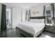 Bright bedroom featuring a gray wood bed frame, luxury vinyl plank flooring, and a door to the outside at 2348 Victoria Dr, Davenport, FL 33837