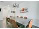 Dining room features a stylish chandelier and wall art, adjacent to the living area at 2348 Victoria Dr, Davenport, FL 33837