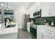 Bright kitchen features white cabinetry, a stainless steel refrigerator, and quartz countertops at 2348 Victoria Dr, Davenport, FL 33837
