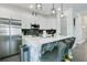 Modern kitchen with white cabinets, stainless steel appliances, and an island with bar seating at 2348 Victoria Dr, Davenport, FL 33837