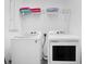 This laundry room features a GE washer and dryer and wire shelving for storage at 2348 Victoria Dr, Davenport, FL 33837