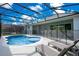 The backyard oasis awaits, featuring a pristine pool, spa, and lounge chairs for relaxation at 2348 Victoria Dr, Davenport, FL 33837