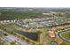 Wide aerial view of the community showcasing the lake, landscaping, and neighborhood at 2371 Victoria Dr, Davenport, FL 33837