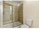 Bathroom features a tiled walk-in shower with glass door and toilet at 2371 Victoria Dr, Davenport, FL 33837