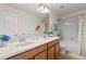 Bathroom features a double vanity, wood cabinets, and a shower and bath combo at 2371 Victoria Dr, Davenport, FL 33837