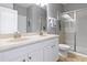 Bright bathroom featuring a dual sink vanity and walk-in shower with glass door at 2371 Victoria Dr, Davenport, FL 33837
