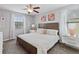 Cozy bedroom with a queen bed, white bedding, and two windows for natural light at 2371 Victoria Dr, Davenport, FL 33837