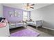 Playful ' bedroom featuring twin beds, a lilac accent wall, and fun decor at 2371 Victoria Dr, Davenport, FL 33837