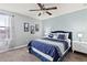 Charming bedroom with a queen bed, ceiling fan, and natural light from window at 2371 Victoria Dr, Davenport, FL 33837