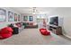 Spacious bonus room features a large sectional, movie decor, and plush carpet at 2371 Victoria Dr, Davenport, FL 33837