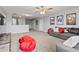 Comfortable bonus room with a large sectional, plush carpet, and movie-themed decor at 2371 Victoria Dr, Davenport, FL 33837