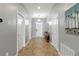 Bright entryway with tile flooring, multiple doors, console table, and modern decor at 2371 Victoria Dr, Davenport, FL 33837