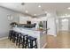 Bright kitchen features white cabinets, stainless steel appliances, and a breakfast bar with seating at 2371 Victoria Dr, Davenport, FL 33837