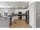 Well-lit kitchen with stainless steel appliances, white cabinets, and a breakfast bar area at 2371 Victoria Dr, Davenport, FL 33837