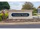Community sign for Victoria Woods subdivision entrance with manicured landscaping at 2371 Victoria Dr, Davenport, FL 33837