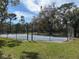 Community basketball court surrounded by lush landscaping and secure fencing at 250 Raintree Dr, Casselberry, FL 32707