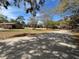 Exterior view of community buildings surrounded by mature trees and lush green grass at 250 Raintree Dr, Casselberry, FL 32707