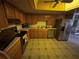 Cozy kitchen with oak cabinets, stainless steel appliances, and tile floors at 250 Raintree Dr, Casselberry, FL 32707