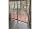 View of outdoor patio through sliding glass doors, featuring tile flooring and vertical blinds at 250 Raintree Dr, Casselberry, FL 32707