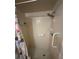 View of shower stall with tile walls, updated shower head, and safety railing at 250 Raintree Dr, Casselberry, FL 32707