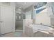 Bright bathroom featuring a soaking tub and a separate glass-enclosed shower at 2724 Sarzana Ln, Apopka, FL 32712