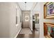 Elegant foyer with hardwood floors, decorative lighting, artwork, and a view into the adjacent living area at 2724 Sarzana Ln, Apopka, FL 32712