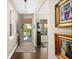 Bright foyer with hardwood floors, artwork, a decorative mirror, and a view of the front porch and yard at 2724 Sarzana Ln, Apopka, FL 32712